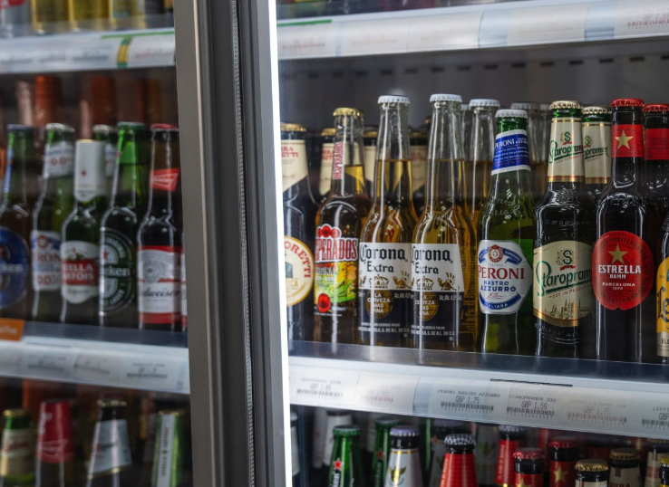 Beer bottles wait in cold refrigerators for consumers